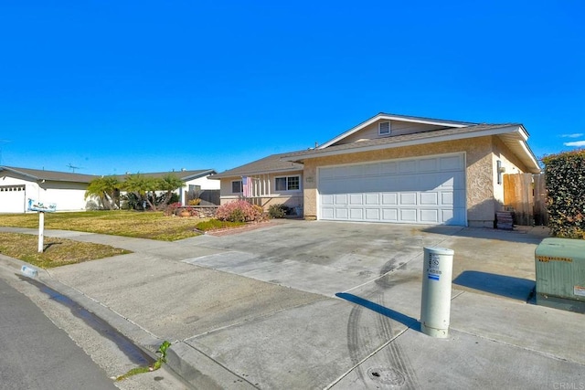 ranch-style house featuring a front lawn and a garage