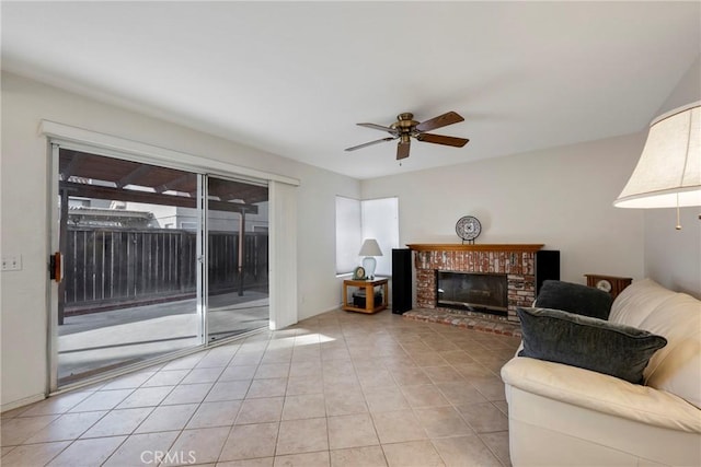 tiled living room featuring a brick fireplace and ceiling fan