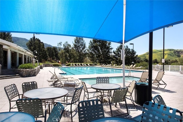 view of pool with a mountain view and a patio