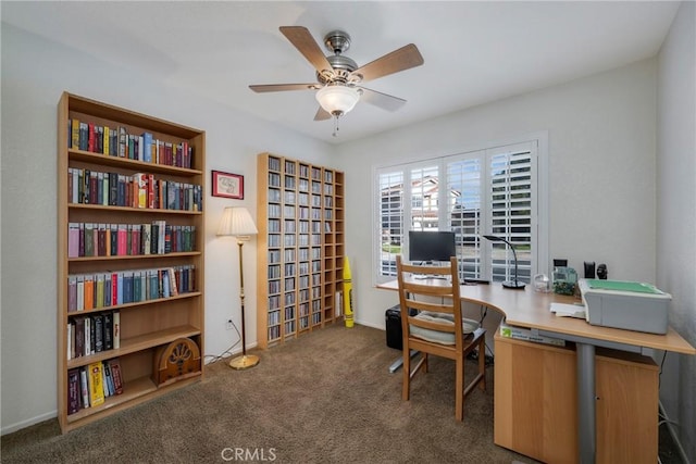 home office with ceiling fan and dark carpet