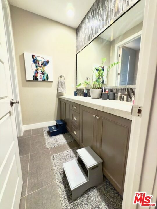 bathroom with tile patterned floors and vanity