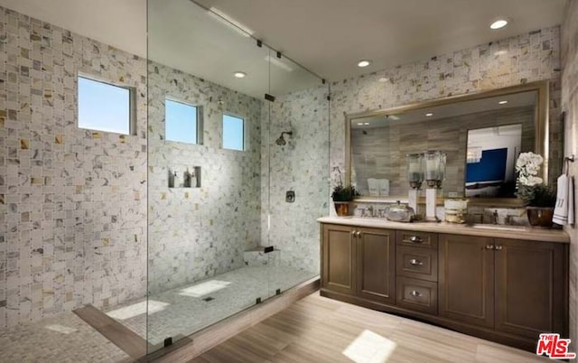 bathroom with vanity and tiled shower