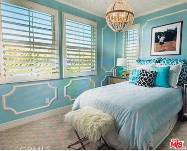 carpeted bedroom with ornamental molding and an inviting chandelier