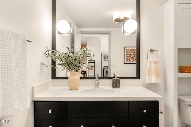 bathroom featuring toilet and vanity