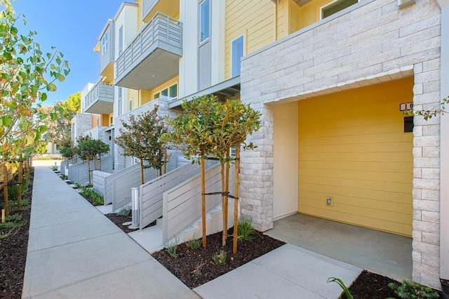 view of exterior entry featuring a balcony