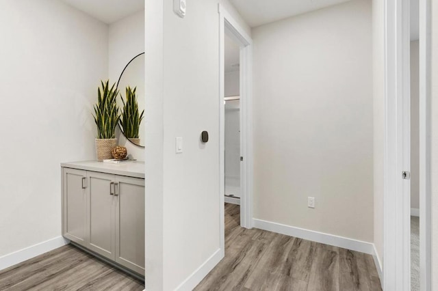 corridor with light hardwood / wood-style floors