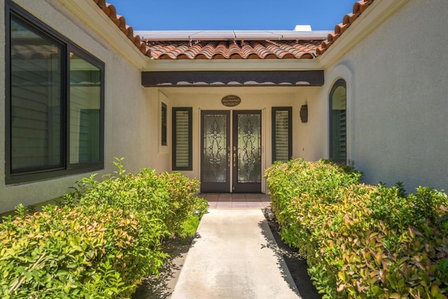 doorway to property with french doors and solar panels