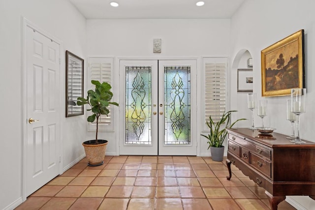 foyer entrance featuring light tile patterned floors and french doors