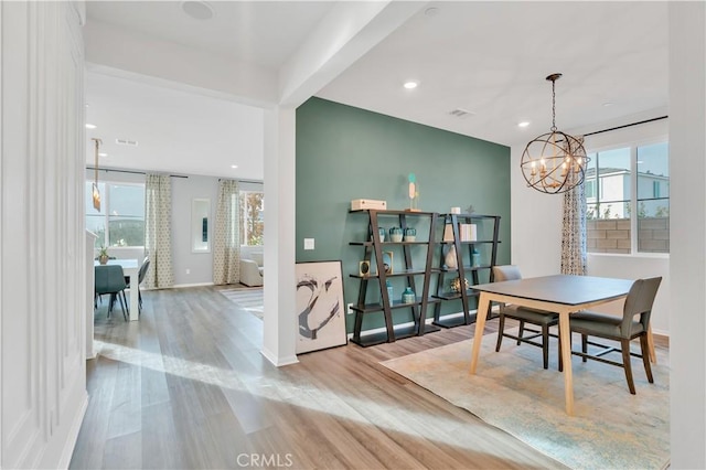 dining area featuring a chandelier and light hardwood / wood-style flooring