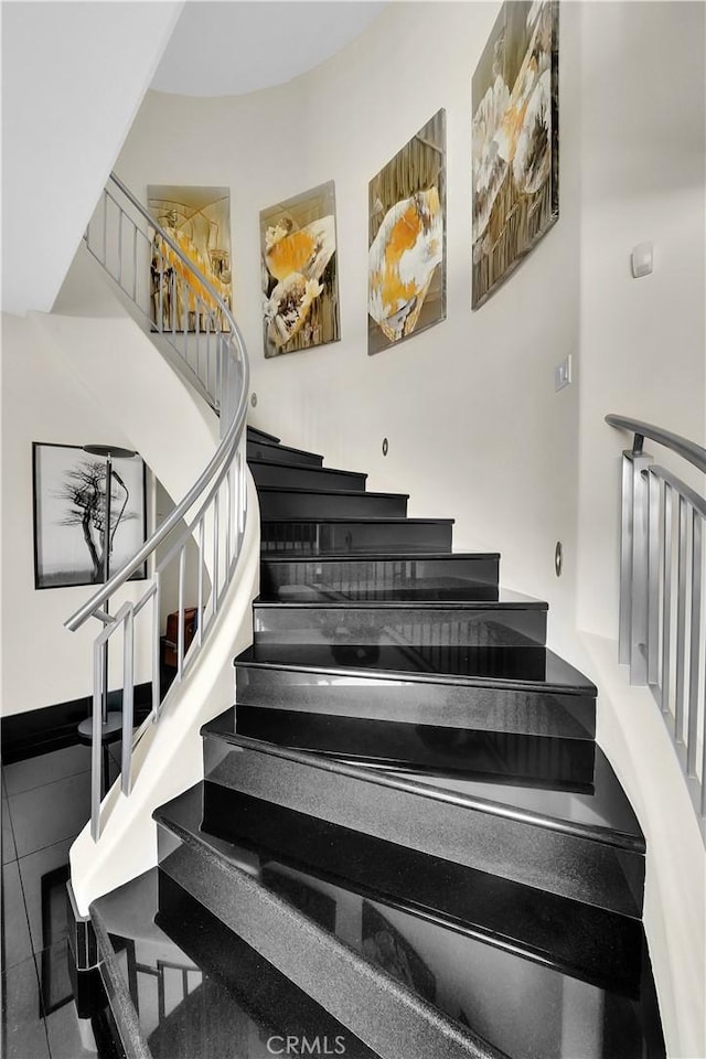 staircase featuring tile patterned flooring
