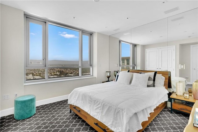 carpeted bedroom featuring baseboards