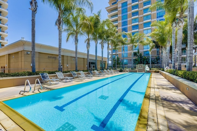pool with fence and a patio area