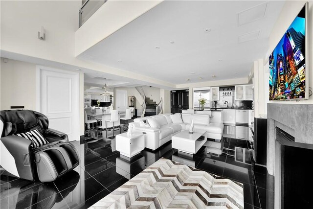 living area with a high end fireplace and stairway