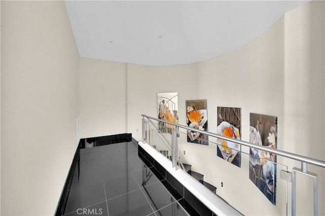stairway with tile patterned floors