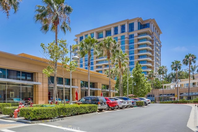 view of building exterior featuring uncovered parking