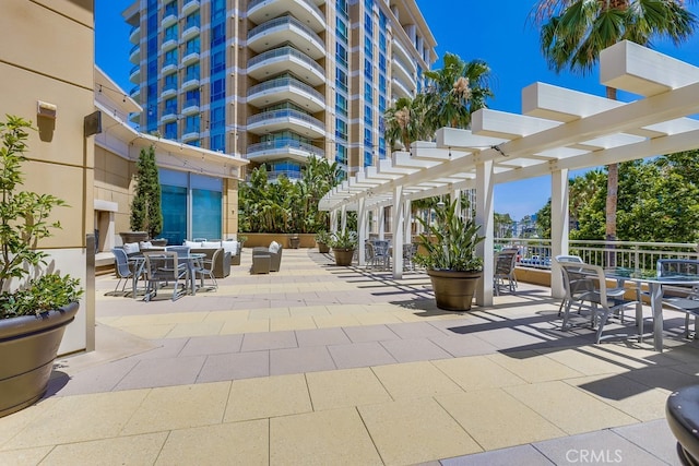 view of patio with a pergola and outdoor dining area