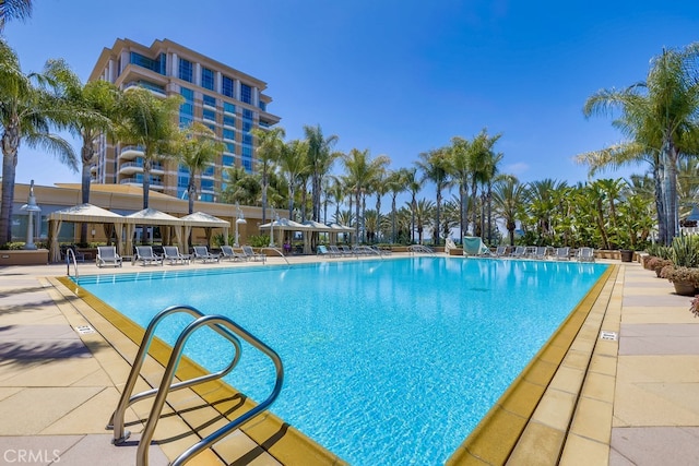 community pool with a patio area