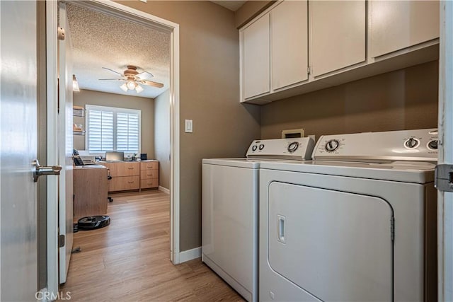 washroom featuring separate washer and dryer, a textured ceiling, cabinets, light hardwood / wood-style floors, and ceiling fan