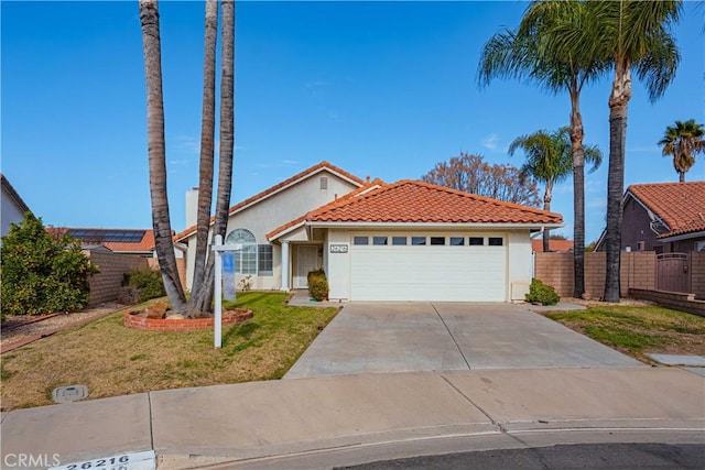 view of front of home featuring a front lawn and a garage