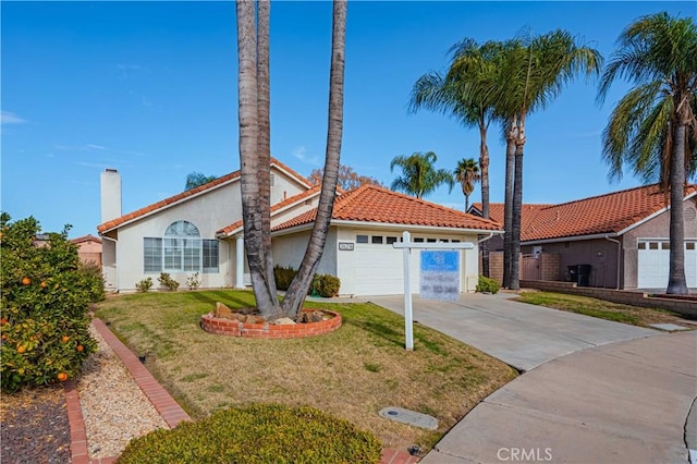 view of front of house with a front lawn and a garage