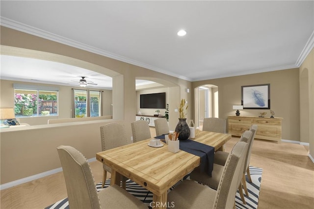 carpeted dining area with ceiling fan and ornamental molding