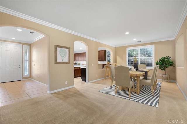 carpeted dining area featuring crown molding