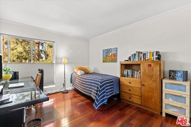 bedroom with crown molding and dark hardwood / wood-style floors