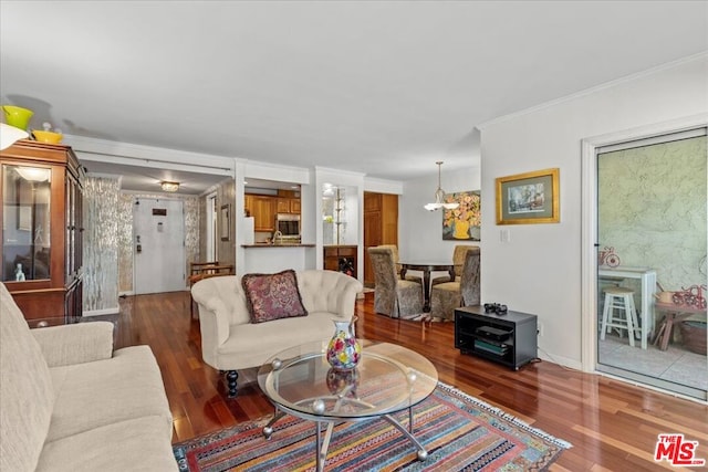 living room featuring dark hardwood / wood-style flooring and a notable chandelier