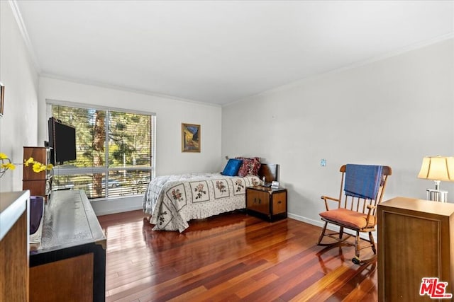 bedroom with dark hardwood / wood-style floors and crown molding