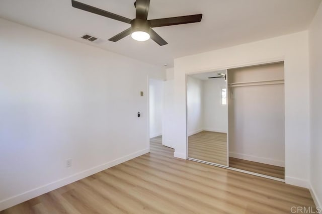 unfurnished bedroom with ceiling fan, a closet, and light hardwood / wood-style flooring