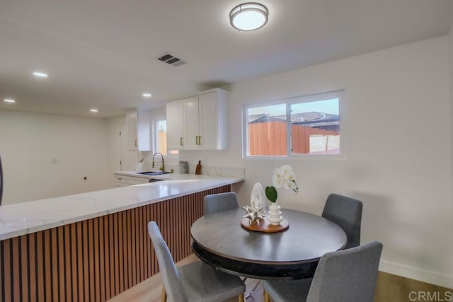 dining space featuring dark hardwood / wood-style flooring and sink