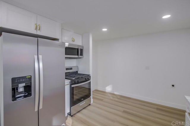 kitchen featuring light hardwood / wood-style flooring, stainless steel appliances, and white cabinetry