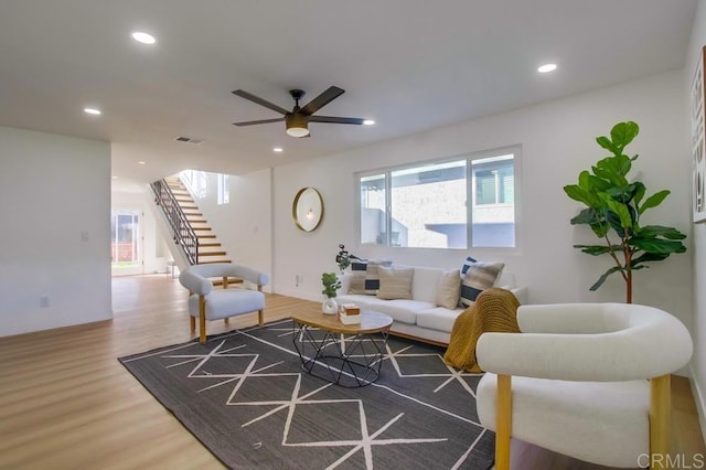 living room with ceiling fan and hardwood / wood-style flooring