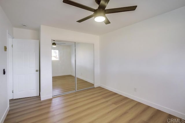 unfurnished bedroom with ceiling fan, hardwood / wood-style flooring, and a closet