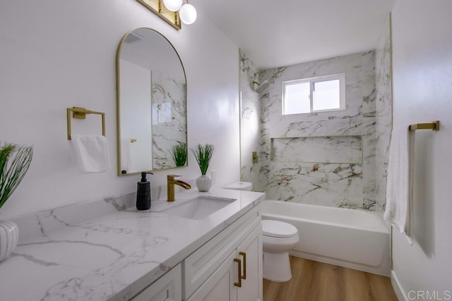 full bathroom featuring toilet, vanity, tiled shower / bath combo, and hardwood / wood-style flooring