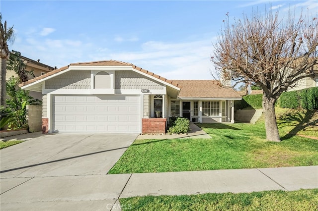 view of front of home featuring a front yard and a garage