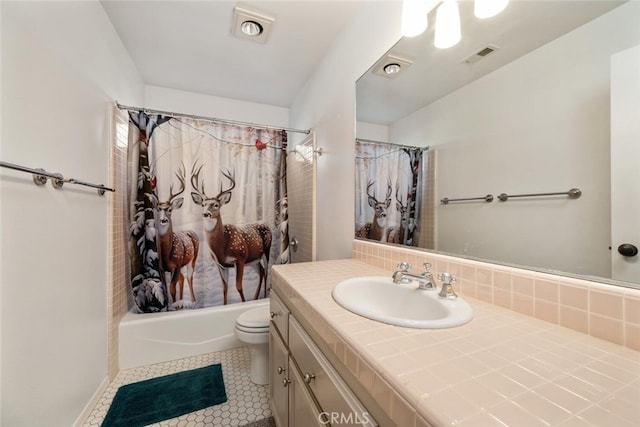 full bathroom featuring shower / tub combo with curtain, toilet, vanity, and tile patterned floors