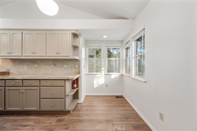 kitchen with tasteful backsplash and light hardwood / wood-style floors