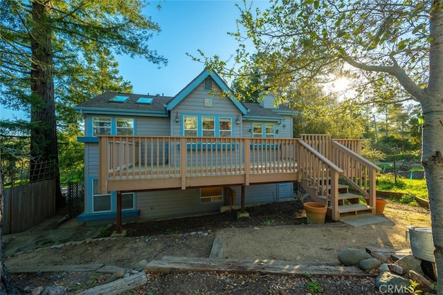 rear view of house with a wooden deck