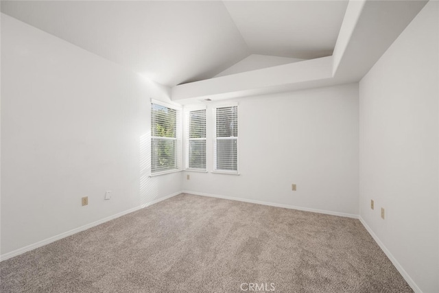 unfurnished room featuring carpet and lofted ceiling