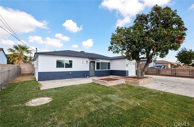 back of house with a garage and a lawn