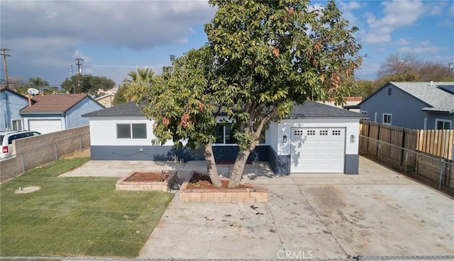 view of front of home with a front lawn, a garage, and an outbuilding