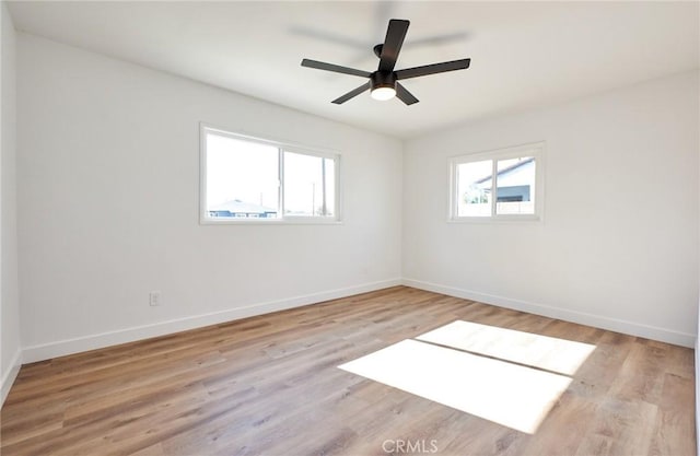 empty room featuring light wood-type flooring and ceiling fan