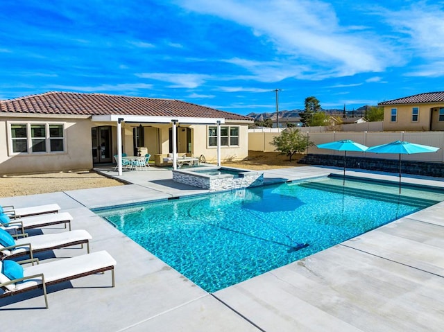 view of swimming pool featuring a patio area, an outdoor structure, and an in ground hot tub