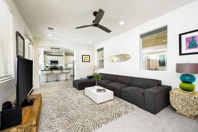 living room with ceiling fan and light tile patterned flooring