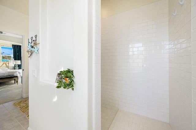 bathroom with tile patterned floors and tiled shower