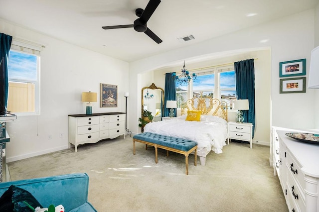 bedroom featuring ceiling fan with notable chandelier and carpet floors