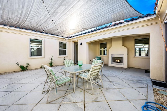 view of patio with exterior fireplace