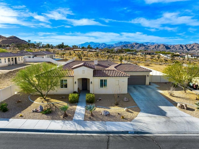 view of front of home featuring a garage and a mountain view