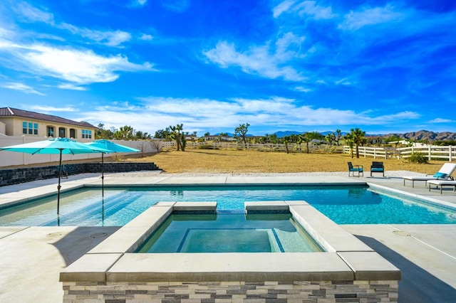 view of pool with a patio area and an in ground hot tub